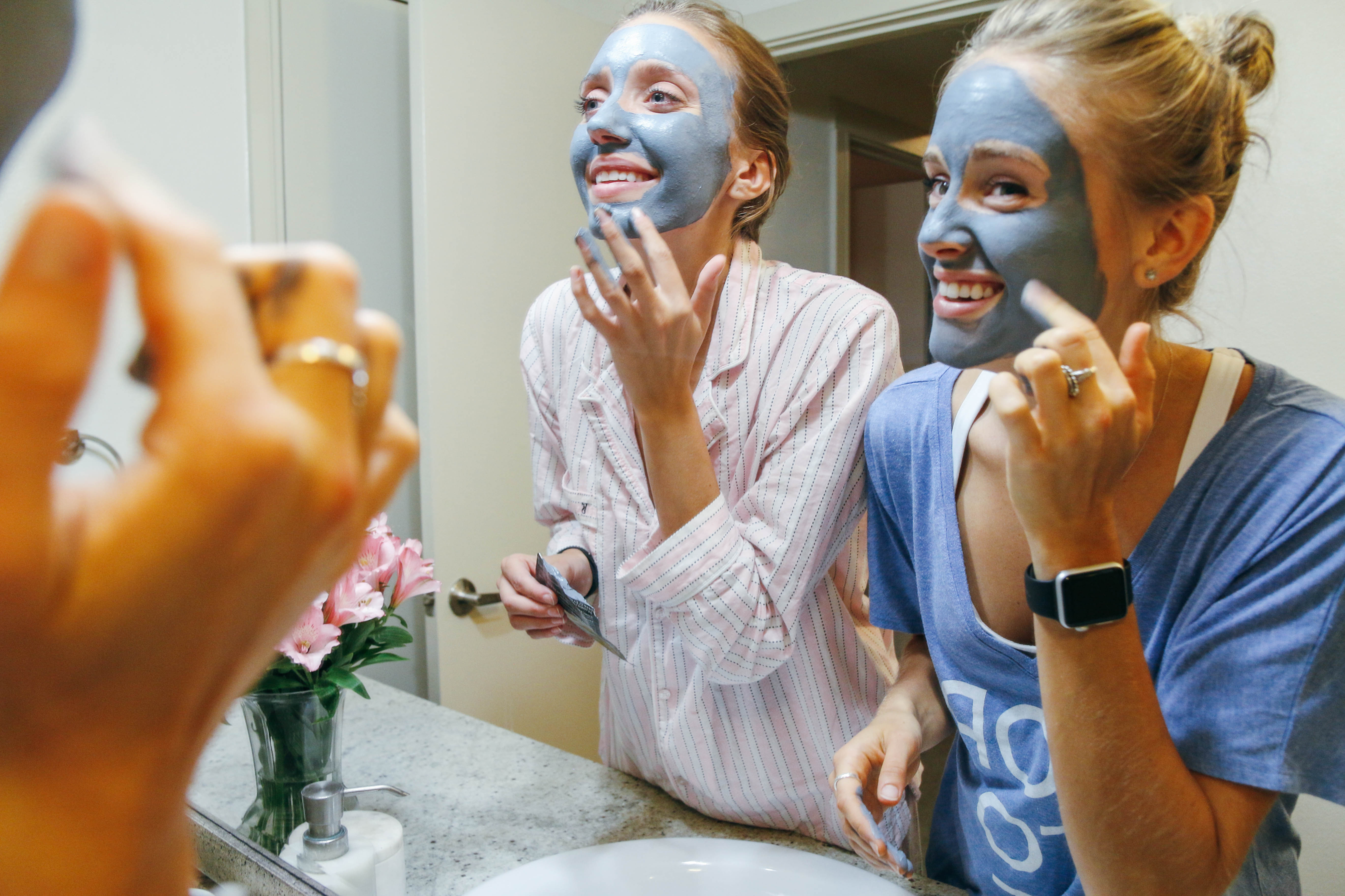 Girls applying face masks in their pajamas