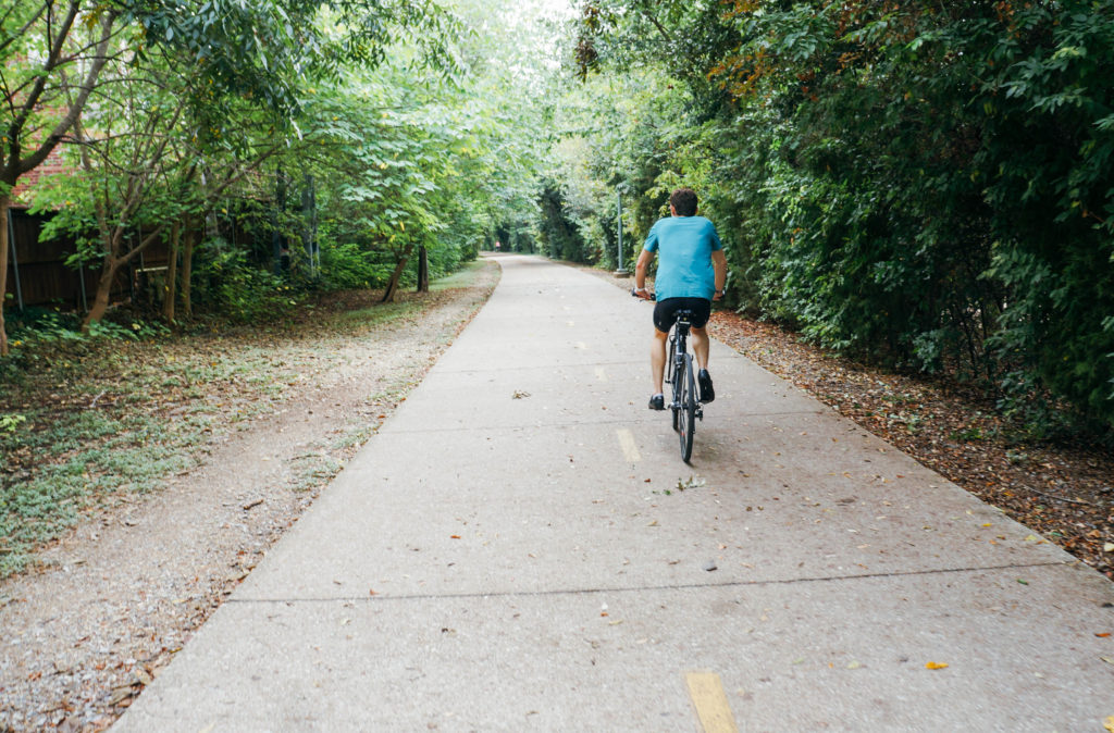 Man riding bicycle on running trail